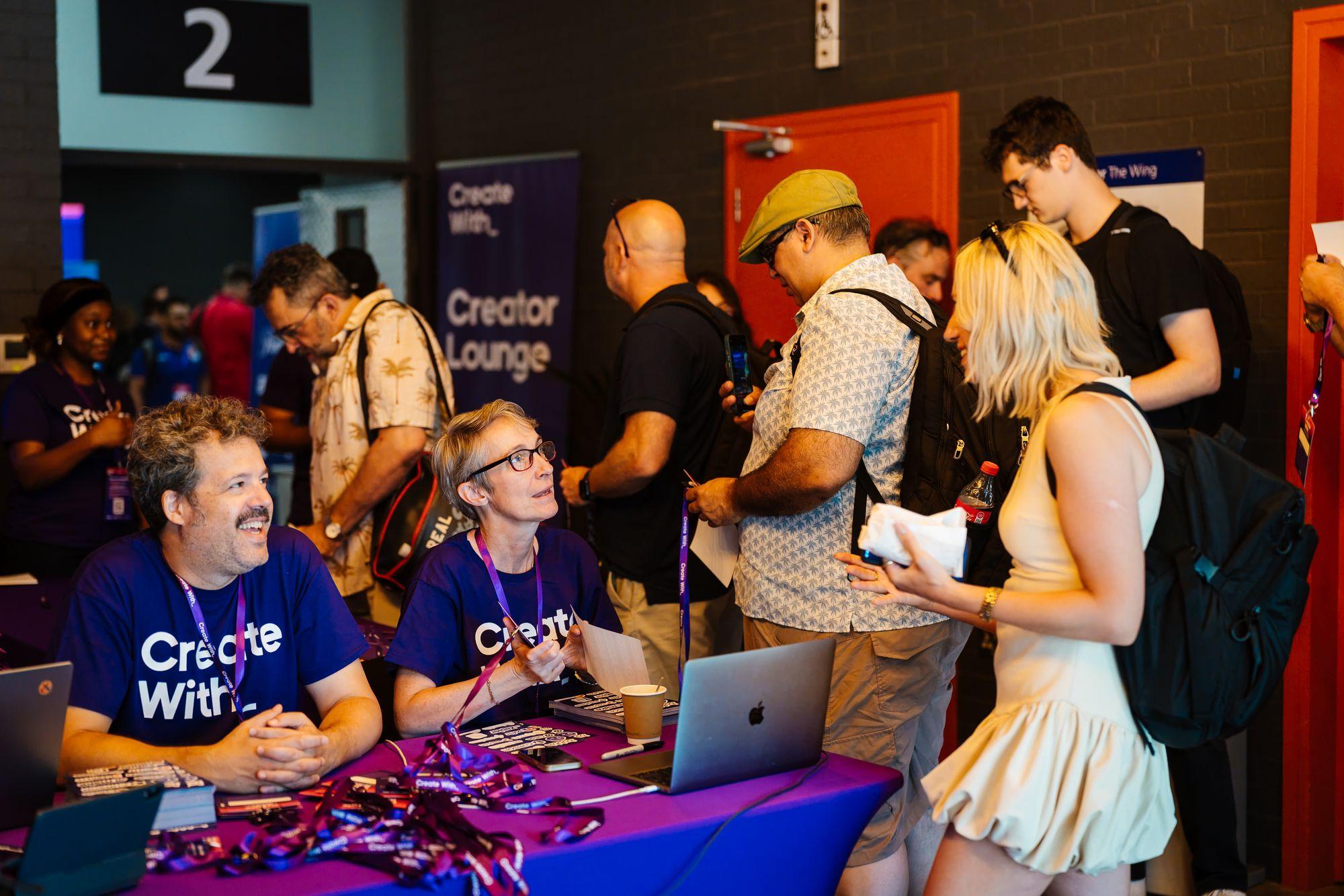 Registration: the Create With team handing out lanyards at the venue entrance