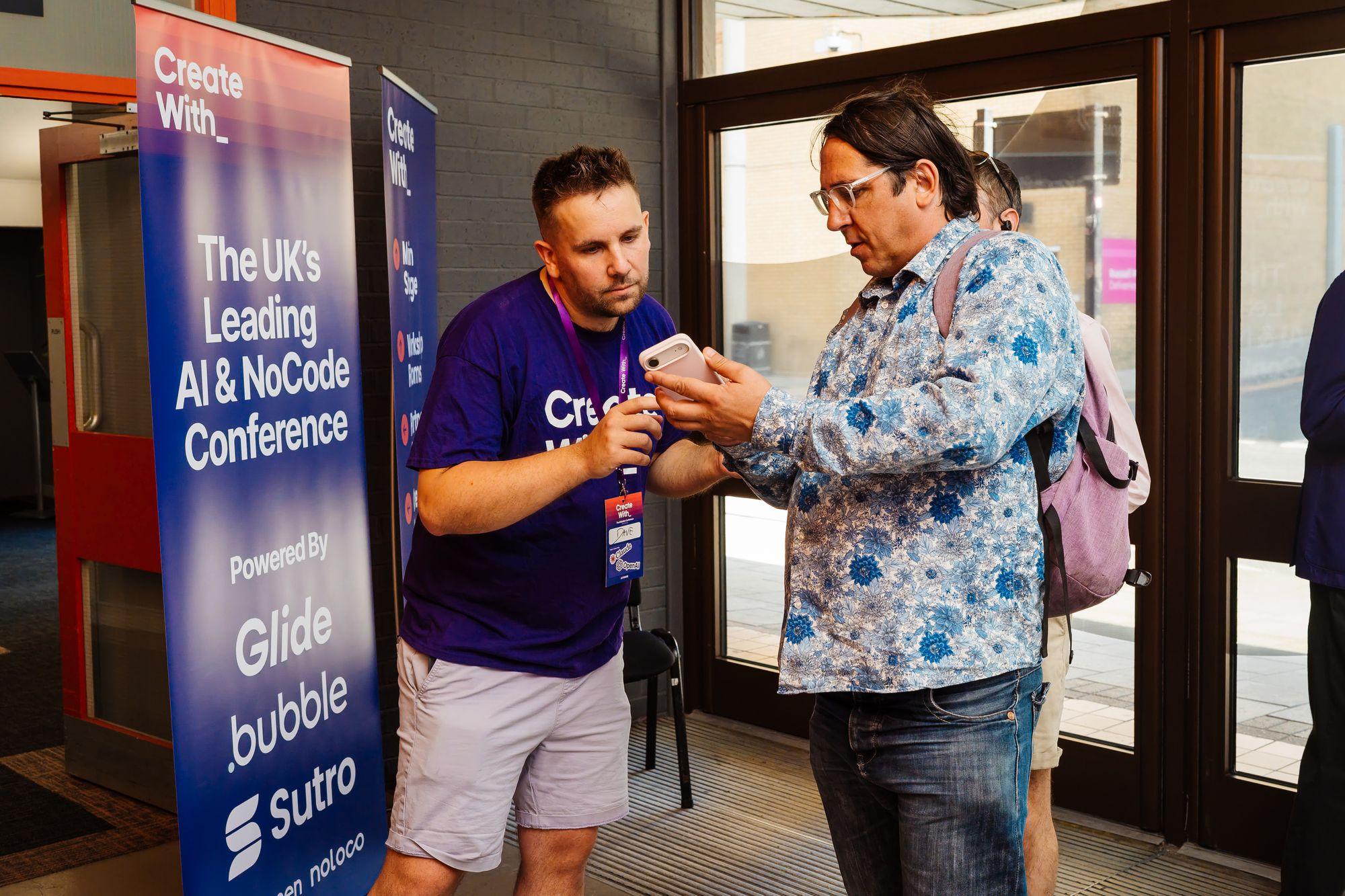 An attendee checking in beside the conference banner at the entrance