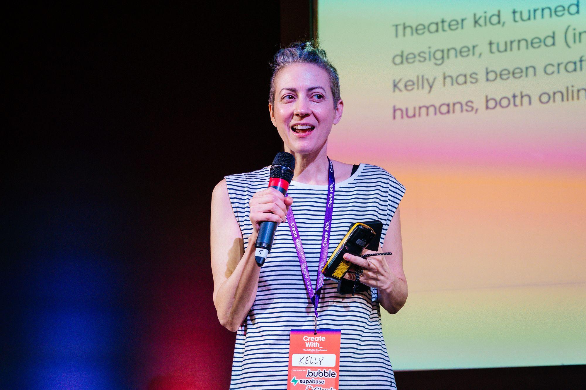 A speaker on the main stage, microphone in hand