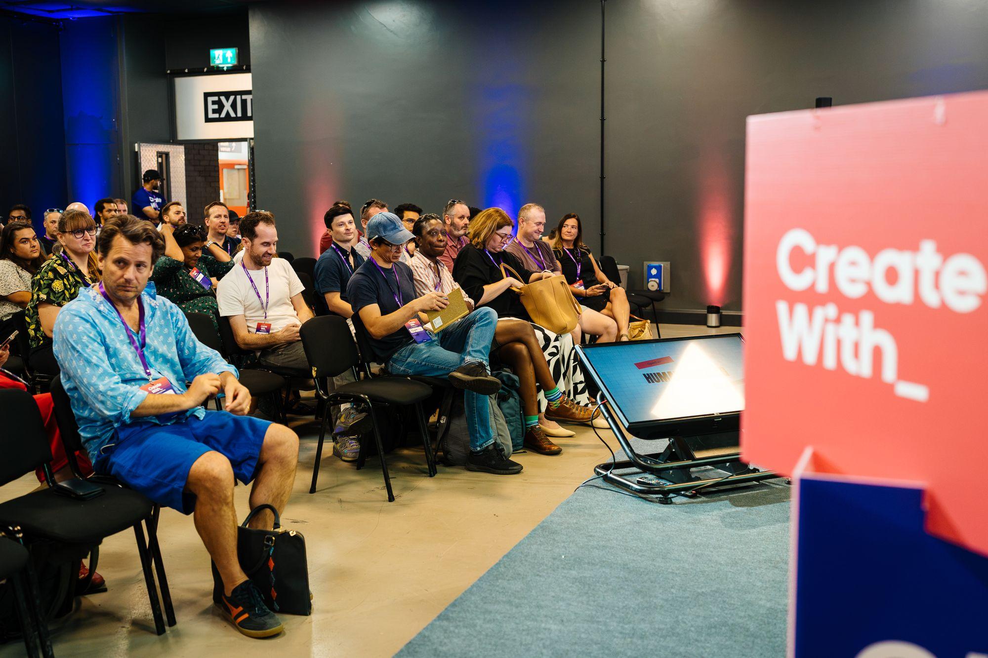 A full workshop room beside the Create With sign