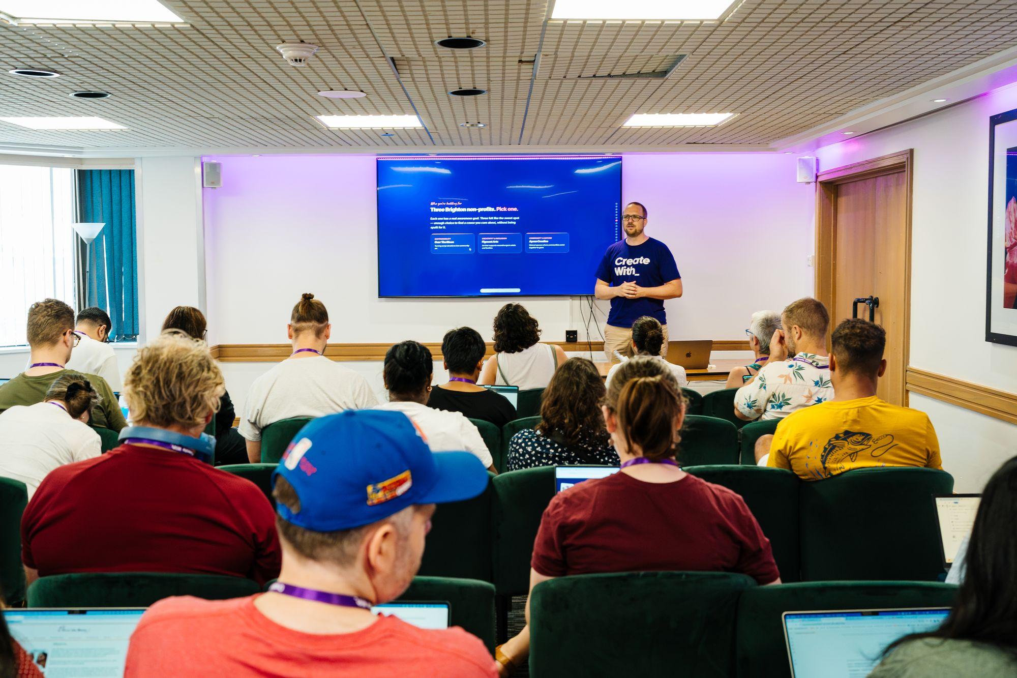 A workshop room with the presenter at the front and attendees seated