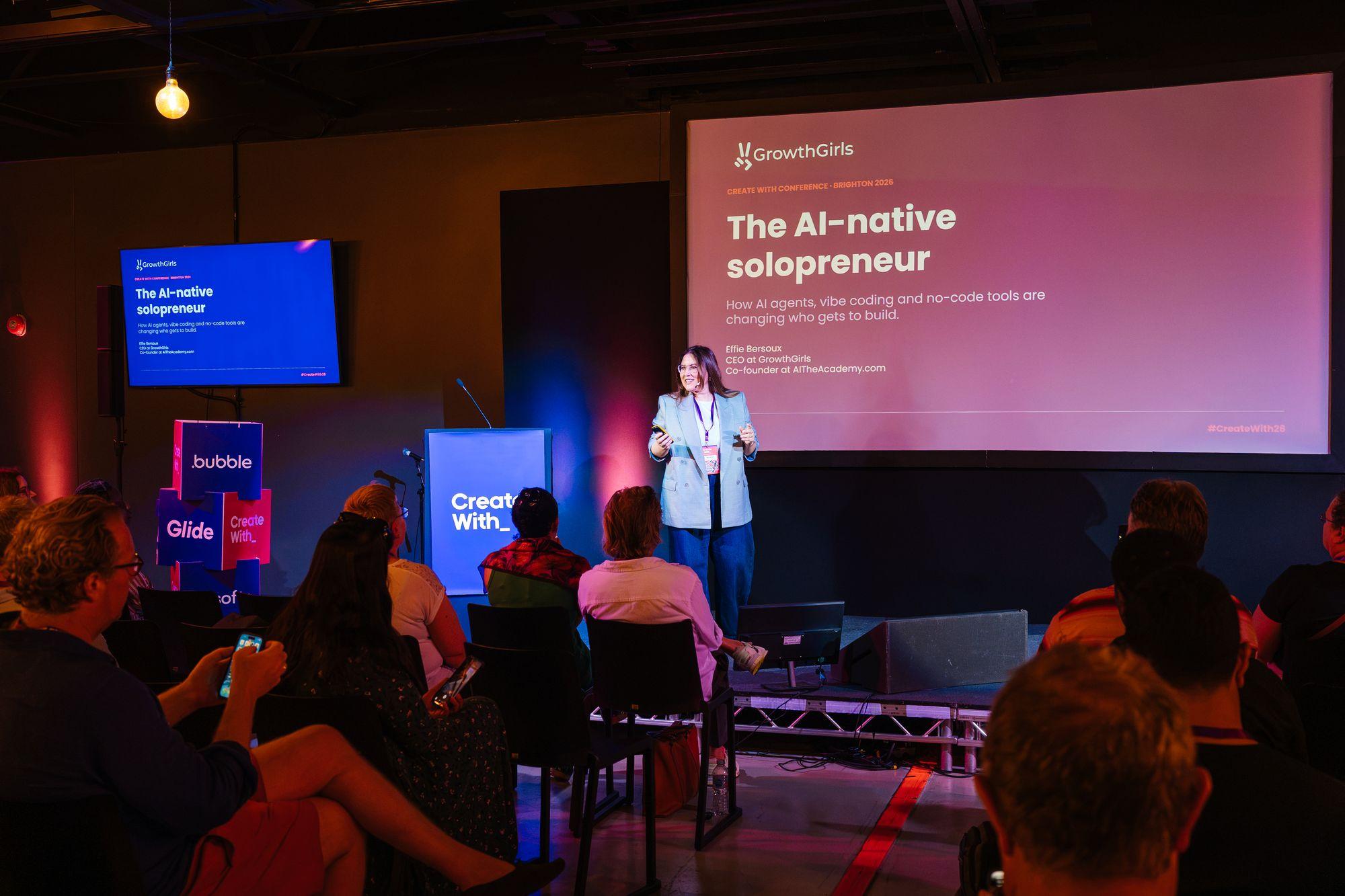 A speaker on stage presenting The AI-native solopreneur