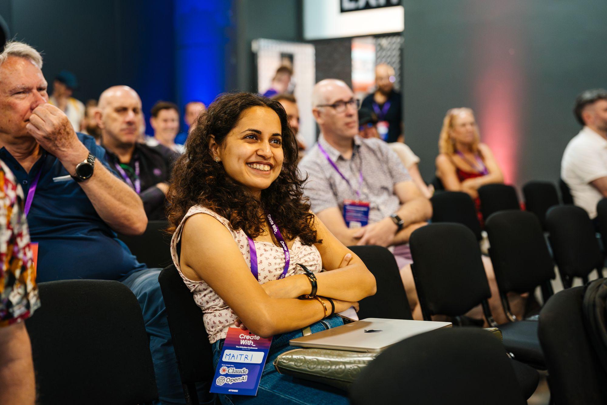 A smiling attendee in the audience