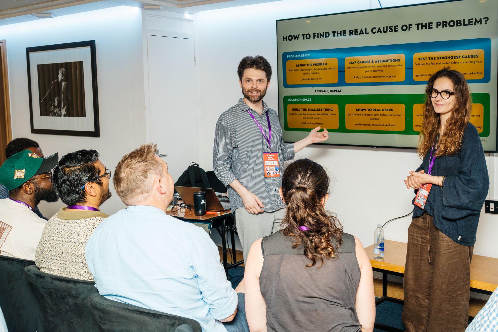 Two facilitators leading a small-group session on finding the real cause of a problem