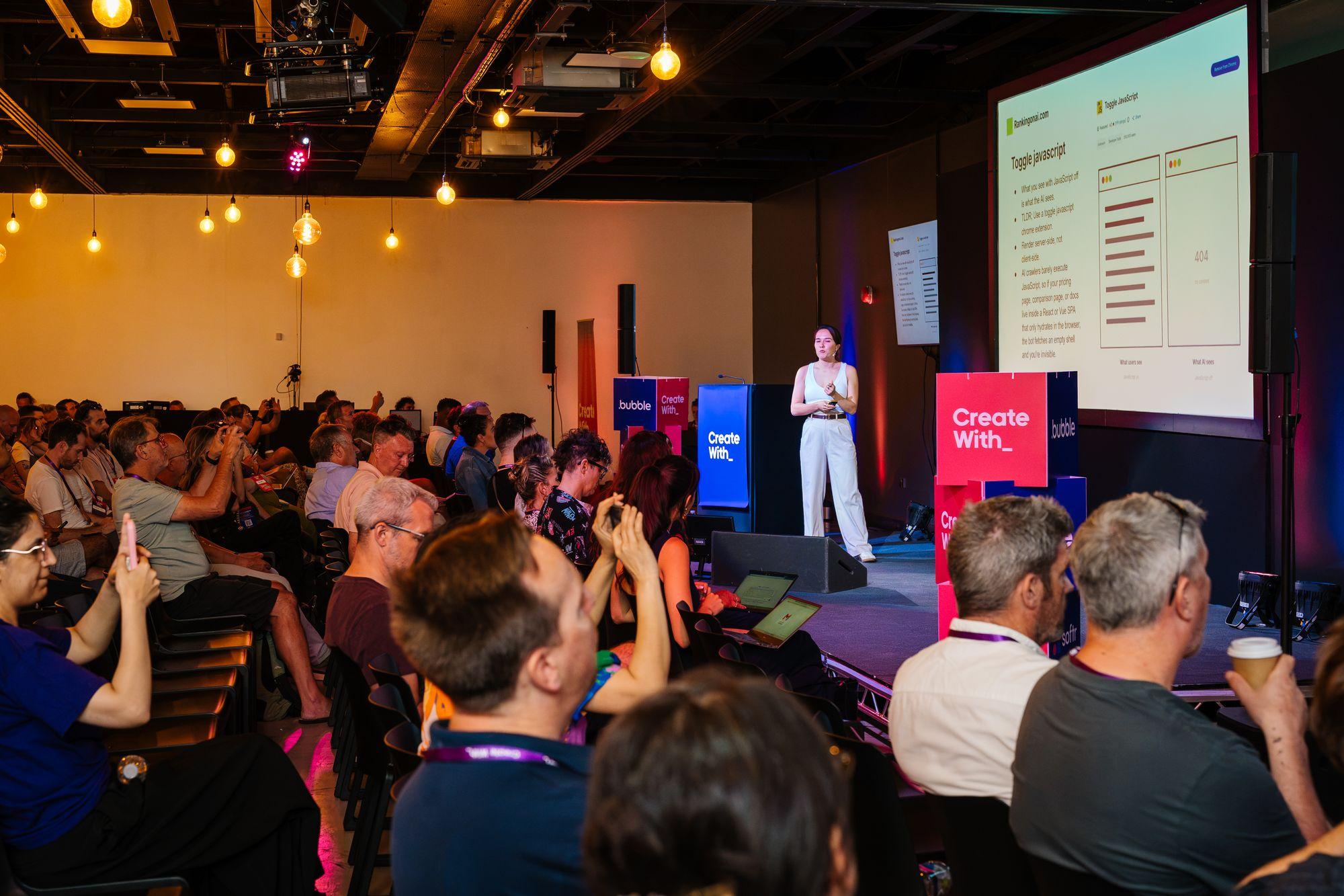 A speaker on stage with the crowd, Create With lectern in front