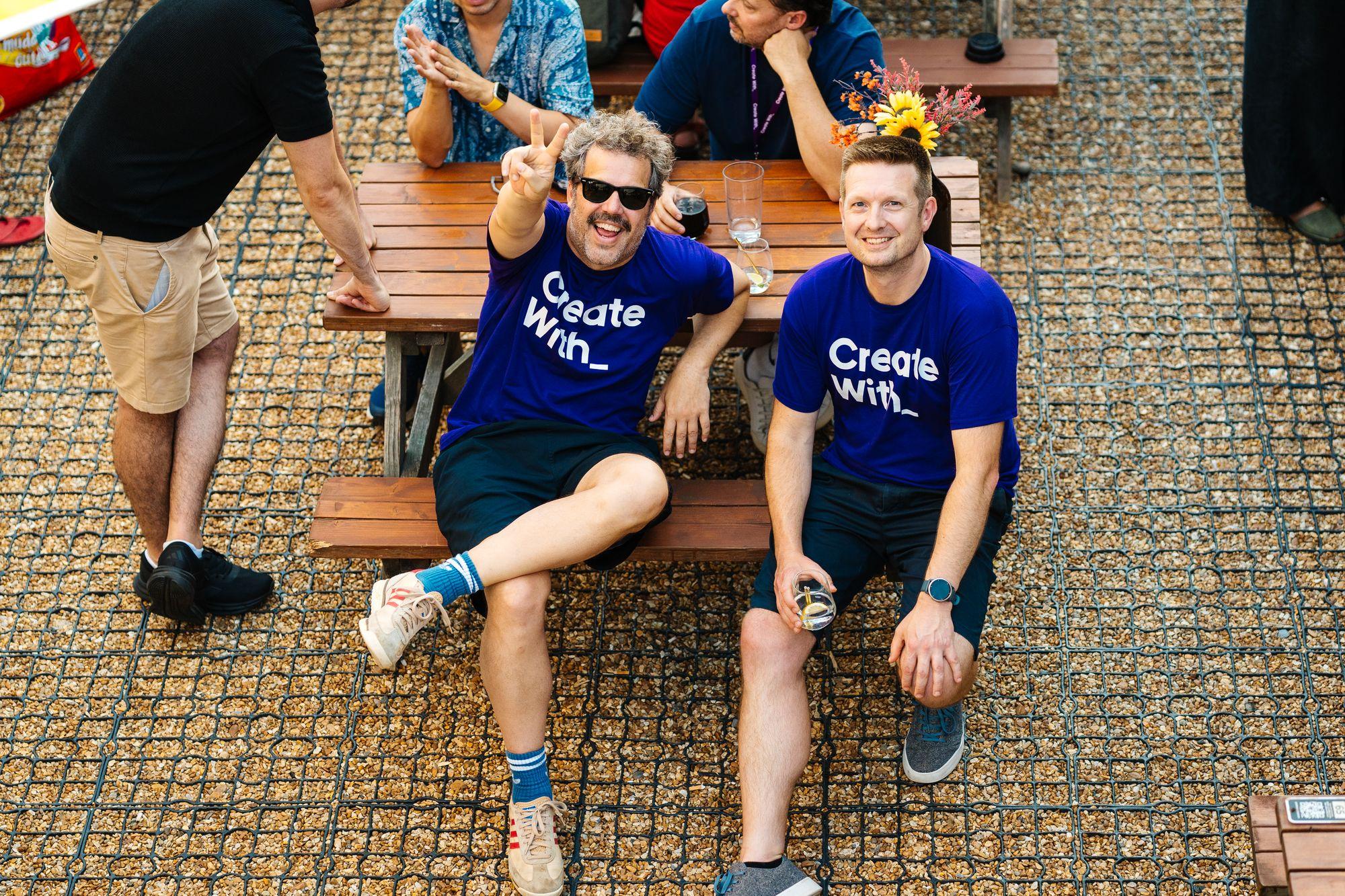 Two Create With team members on a bench at the afterparty