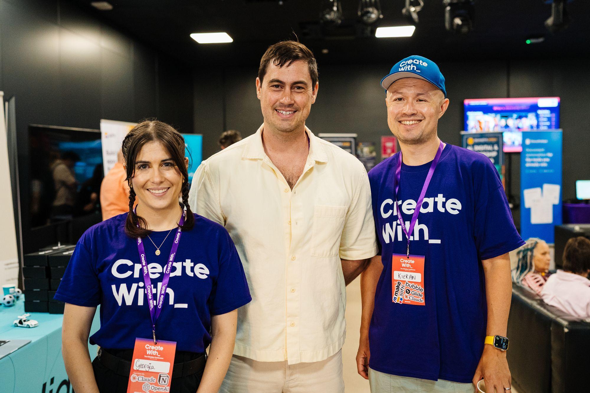 Three people at a stand in Create With shirts