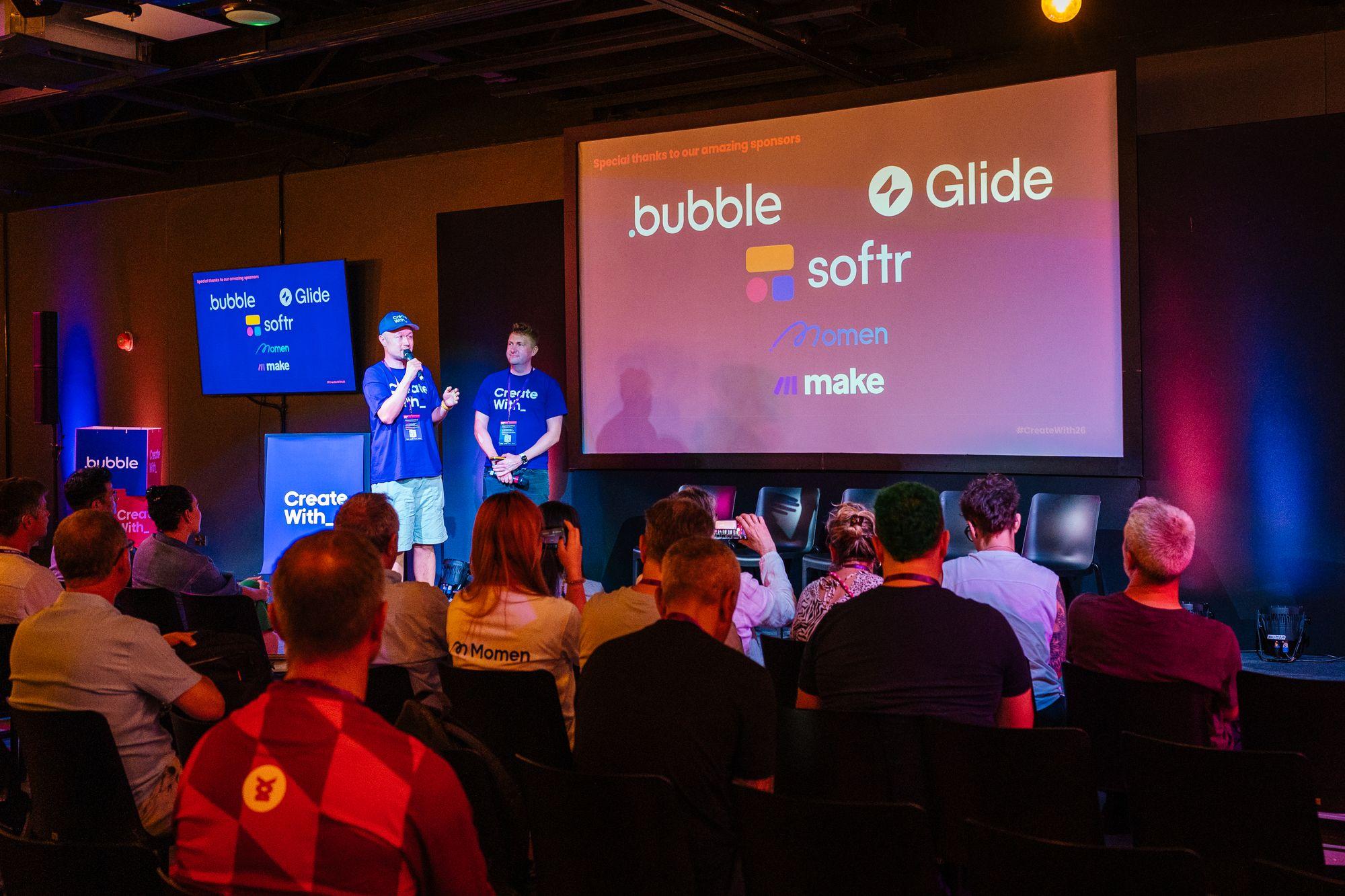 The main stage with sponsor logos on screen: Bubble, Glide, Softr, Make